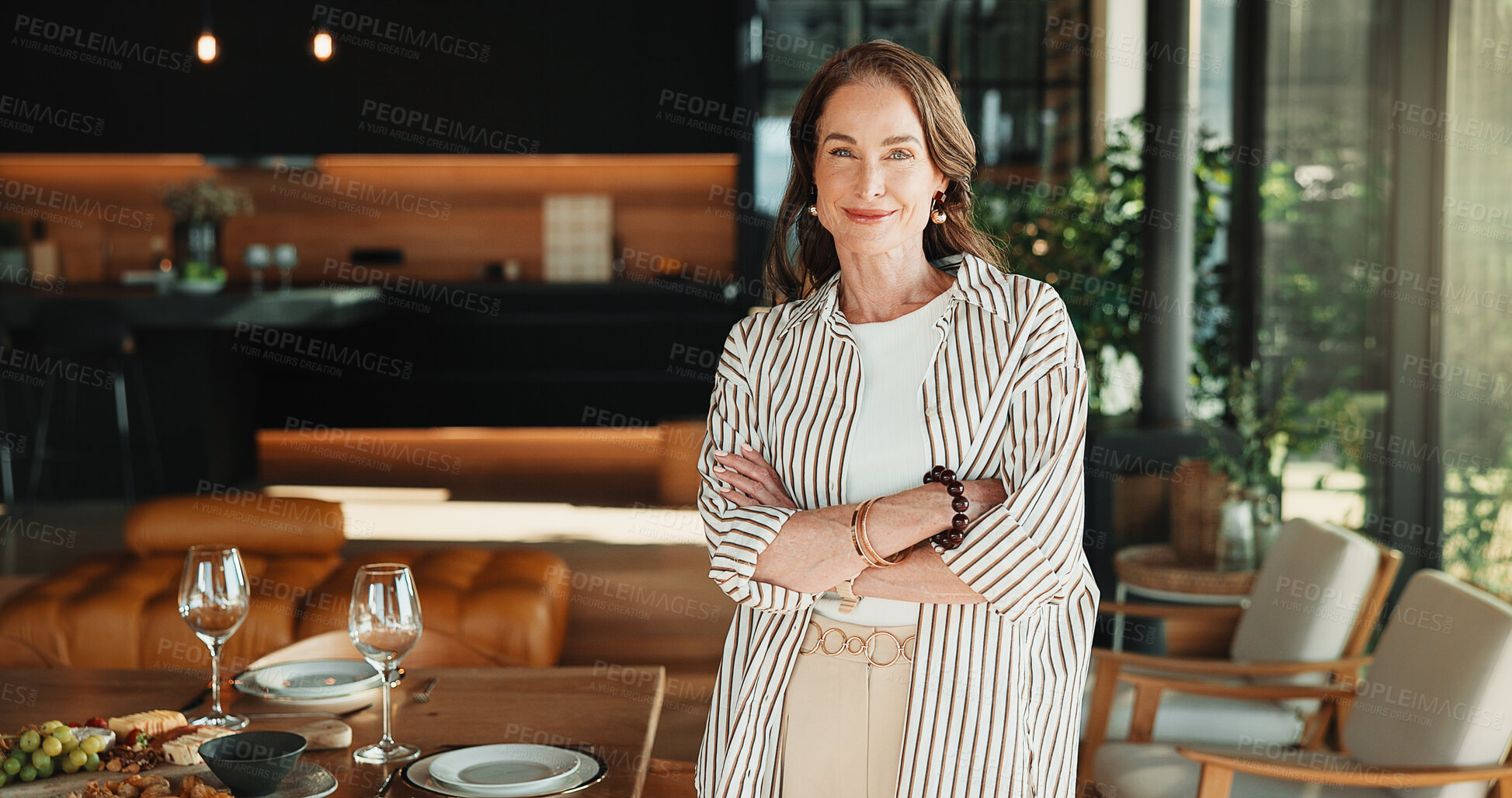 Buy stock photo Host, portrait and woman in house with arms crossed, happy moment and confidence with party planning. Wellness, smile and mature person with meal, satisfaction and optimism in dinner preparation.
