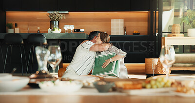 Buy stock photo Couple, gift or hug in home with love, birthday celebration or relationship bonding with care. Mature woman, husband or together in living room with connection, trust or embrace to appreciate present