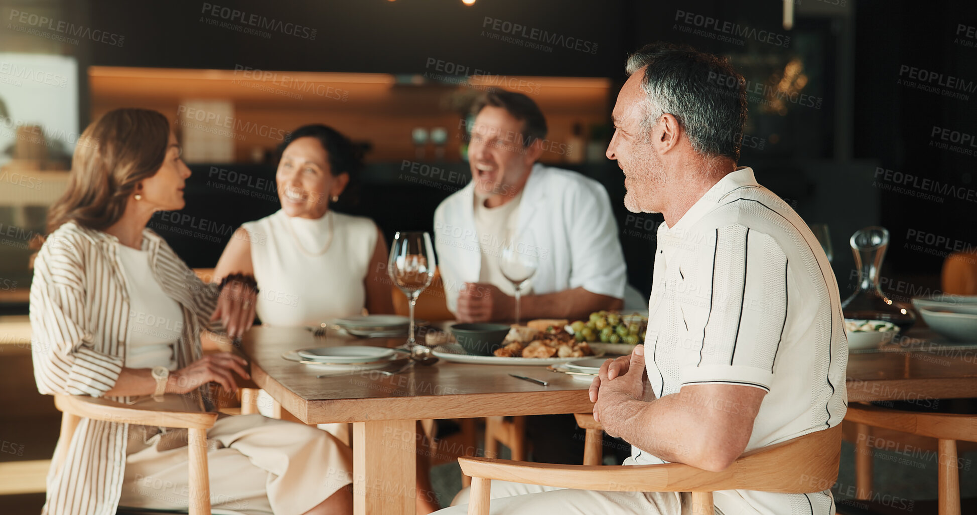 Buy stock photo Celebration, smile and friends in home with meal, bonding together and happy moment with reunion. Discussion, group and mature people with dinner, party connection and good time with social gathering