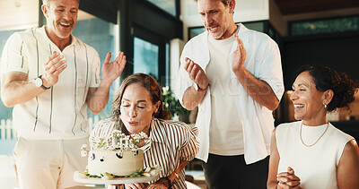 Buy stock photo Blowing, candles and group with birthdays cake, home and laughing together in party and celebration. Friends, clapping and mature people with dessert for event, happiness or social gathering in house
