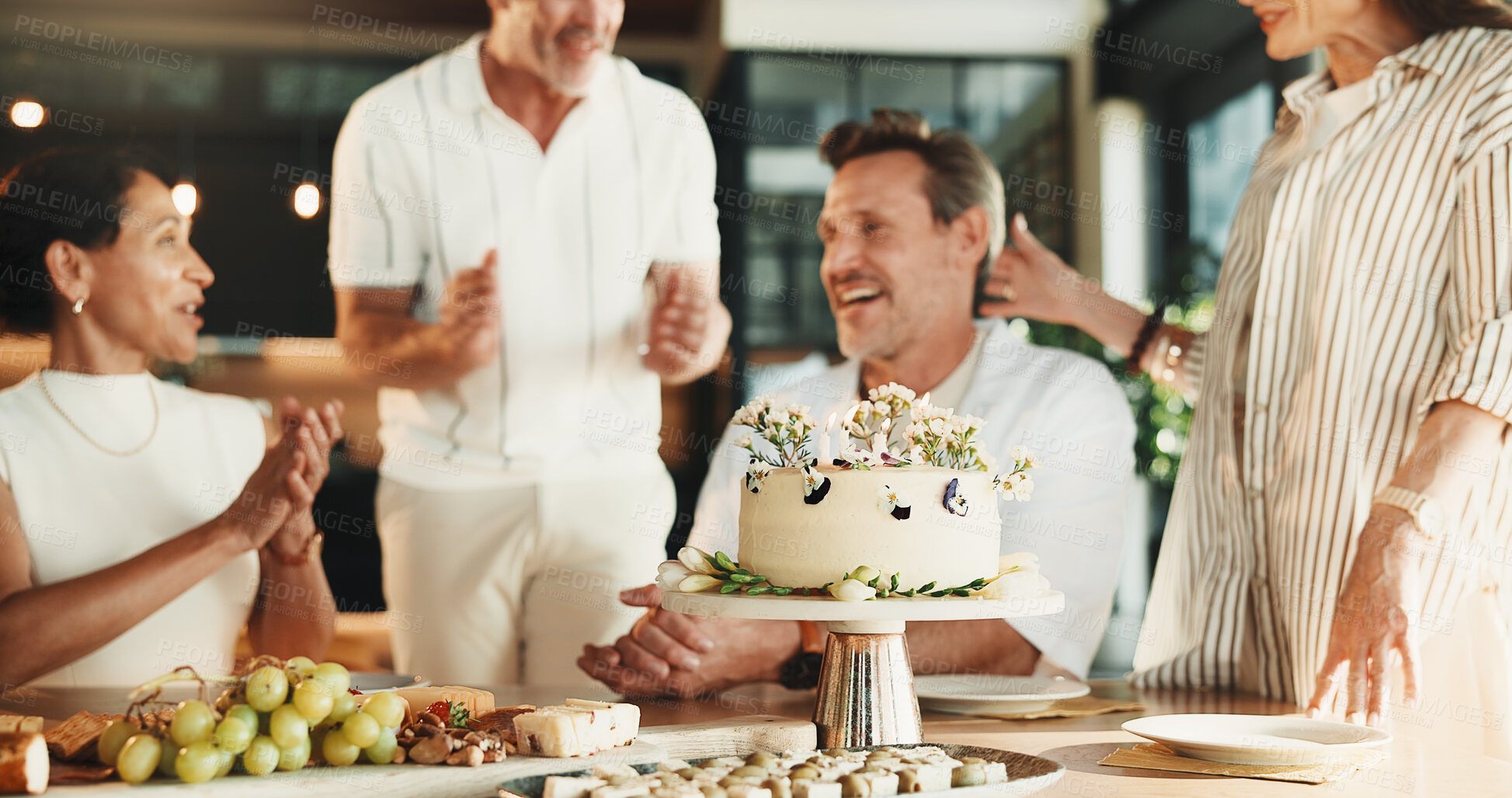 Buy stock photo Happy, friends and candles in house with birthday cake, bonding together or applause for milestone. Mature people, clapping and special day celebration in dining room with dessert, support and party.