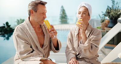 Buy stock photo Drinks, couple and relax at swimming pool on holiday, summer break and bonding together at spa. Poolside, mature man and woman with mimosa cocktail, vacation getaway and love at luxury resort outdoor