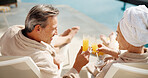 Drinks, couple and toast by swimming pool on holiday, summer break and smile together at spa. Poolside, mature man and woman cheers with mimosa, anniversary vacation and love celebration outdoor