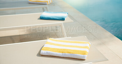 Buy stock photo Empty, chair and towel at hotel with swimming pool, guest comfort and reserved seating on holiday. Fabric, poolside and sun lounger at retreat with amenity, sunbathing and hospitality on vacation
