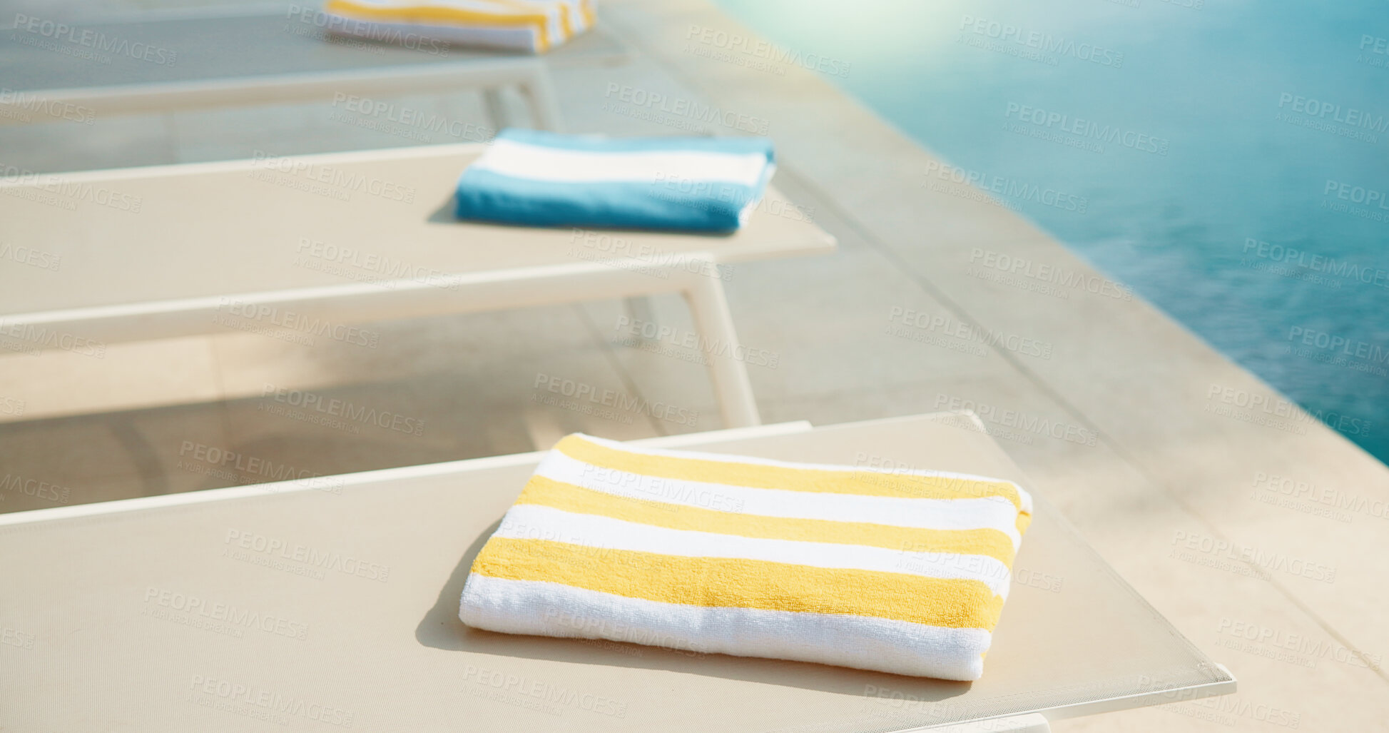 Buy stock photo Empty, chair and towel at hotel with swimming pool, guest comfort and reserved seating on holiday. Fabric, poolside and sun lounger at retreat with amenity, sunbathing and hospitality on vacation