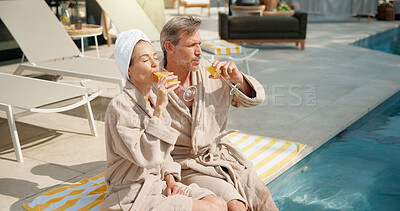 Buy stock photo Drinks, couple and relax at swimming pool on summer vacation, break and bonding together on getaway. Poolside, mature man and woman with mimosa cocktail, holiday or outdoor at luxury resort with love
