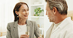 Couple, anniversary and smile with champagne in home and bonding with partner and laughing together. Relationship, commitment and happy mature people with alcohol, conversation and love in house