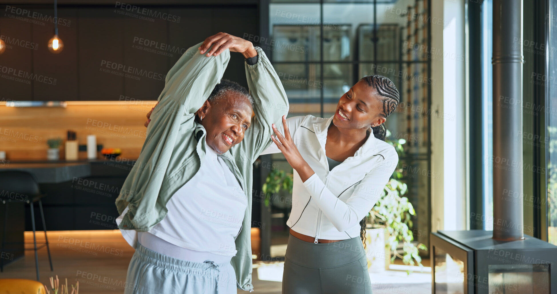 Buy stock photo Personal trainer, stretching and support with black women in home for help, geriatric health or fitness. Physical therapy, rehabilitation or warm up with senior person in house for low impact workout