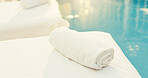 Spa, empty and towel on bed at resort for aromatherapy, beauty treatment and calm for wellness. Hospitality, background and massage table for stress relief, holistic therapy and skincare by pool