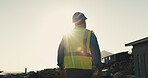 Technician, man and thinking at construction site with city view, inspection and vision for project. Back, flare and person outdoor in town with building evaluation, infrastructure or electrician job