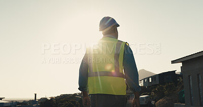 Buy stock photo Technician, man and thinking at construction site with city view, inspection and vision for project. Back, flare and person outdoor in town with building evaluation, infrastructure or electrician job