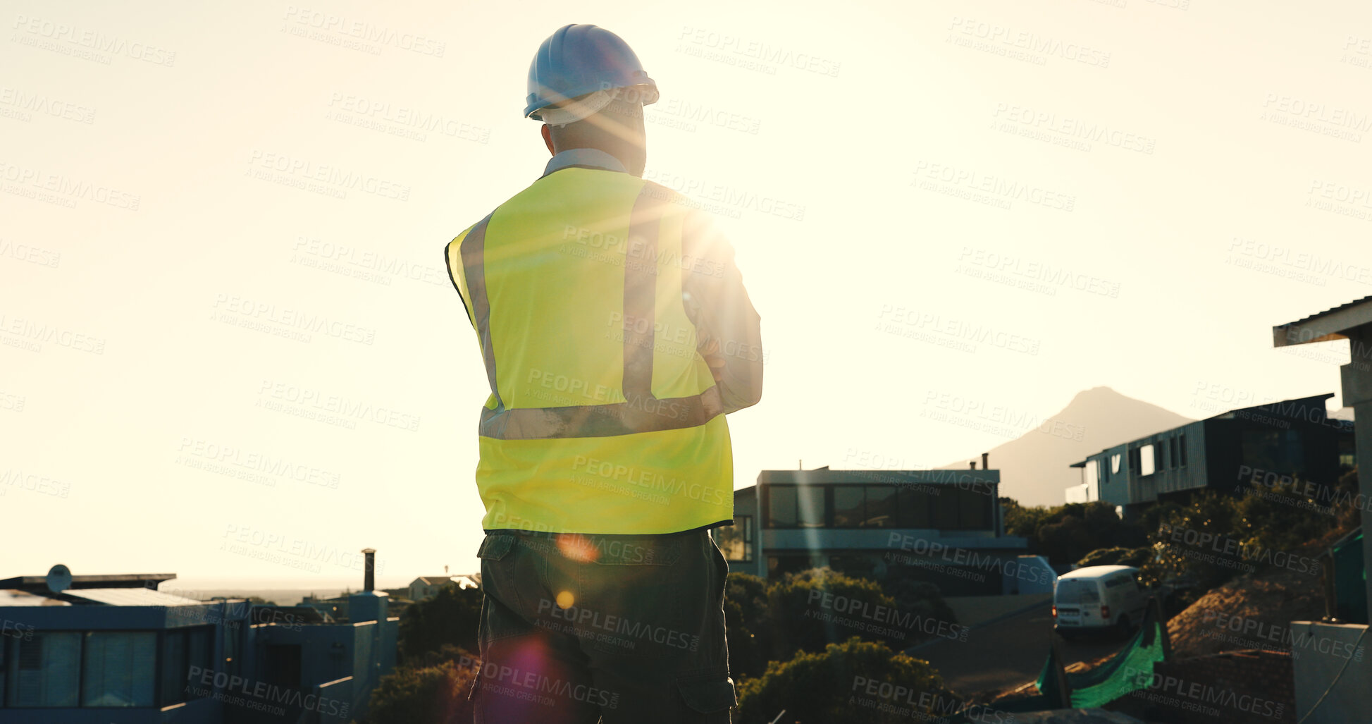 Buy stock photo Technician, man and thinking at construction site with suburb view, decision or planning for project. Back, flare or person outdoor with building evaluation, infrastructure review or electrician job.