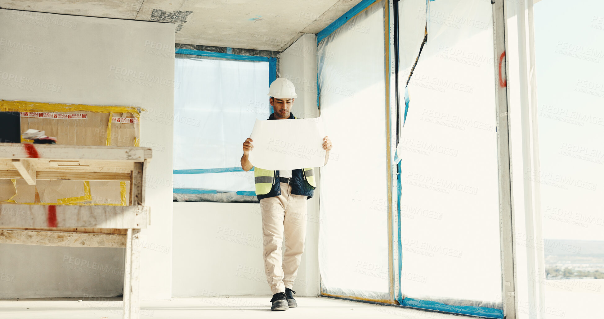 Buy stock photo Construction, blueprint and man in building for inspection, floor plan and evaluation for property. Architecture, walking and person with paperwork for remodeling, development and renovation design
