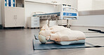 Hospital, mannequin and healthcare training with CPR equipment, life support course or class. Clinic, first aid and dummy for medical simulation practice on floor, rescue education or emergency care