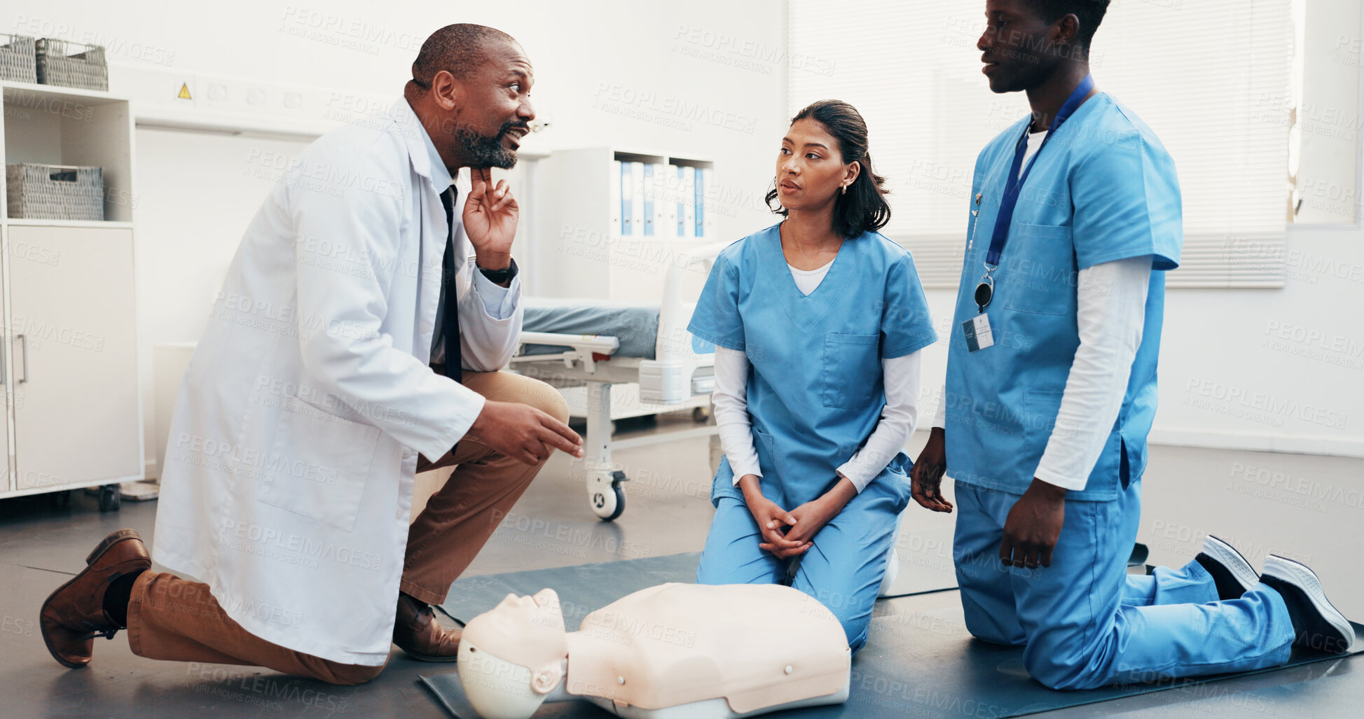 Buy stock photo Medical, team and doctor demonstration for cpr training, artery location and technique with dummy. People, physician and nurses with mannequin, check carotid pulse and explain life saving procedure