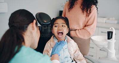 Buy stock photo Open, mouth and dentist with child for appointment, consulting and medical service for oral care. Healthcare, orthodontist and girl with parent for hygiene, teeth cleaning and dental checkup for gums