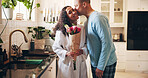 Happy, couple and kiss with flowers in home for romance, anniversary celebration or affection. Man, woman or intimacy with embrace, gift or bouquet of roses for valentines day or date in house