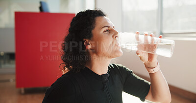 Buy stock photo Woman, fitness and drinking water in gym for wellness, rehydration or body detox or refreshing. Girl, thirsty or bottle in studio for electrolytes, mineral beverage or healthy lifestyle for self care