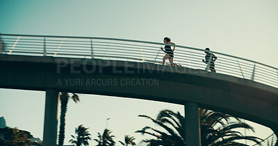 Buy stock photo People, running and bridge for fitness, workout and wellness in low angle, urban town and exercise. Couple, runner or athlete training for resilience, outdoor and morning for health, cardio and sport
