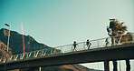 People, running and bridge for fitness, exercise and wellness in low angle, urban town and space. Couple, runner or athlete training for resilience, outdoor and morning for health, cardio and sport