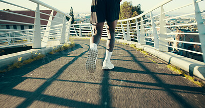Buy stock photo Feet, running and man in city for fitness, cardio training and fast for wellness exercise on bridge. Outdoor, legs and back of person for sprinting, muscle development or workout challenge on asphalt