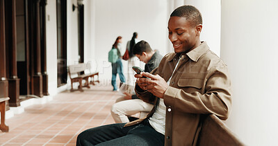 Buy stock photo Happy, student and man at university with phone, social media and search for scholarship on website. Person, smile and typing outdoor on campus with tech, app and browsing online for college grant.