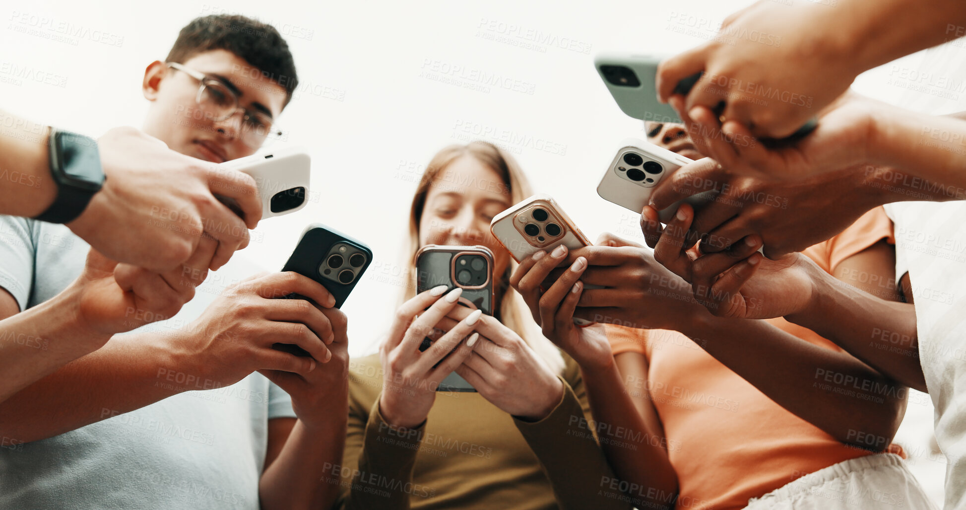 Buy stock photo Hands, friends and phone for connection outdoor, share contact or networking on social media. Group, people or low angle with mobile for communication together, download community app or text message