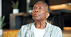 Black woman, breath and retirement at house for yoga, holistic balance or spiritual healing for zen. Senior person, exhale or yogi in home for meditation, inner peace and practice chakra for wellness