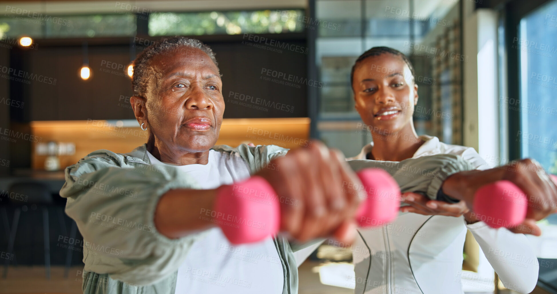 Buy stock photo Personal trainer, weights and fitness with black women in home for help, geriatric health and support. Exercise instructor, wellness and dumbbell with senior person in house for low impact workout
