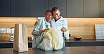 Family, hug and women with grocery in kitchen, laughing and connection with senior mother in house. Black person, embrace and elderly parent with shopping bag, happiness and bonding in apartment
