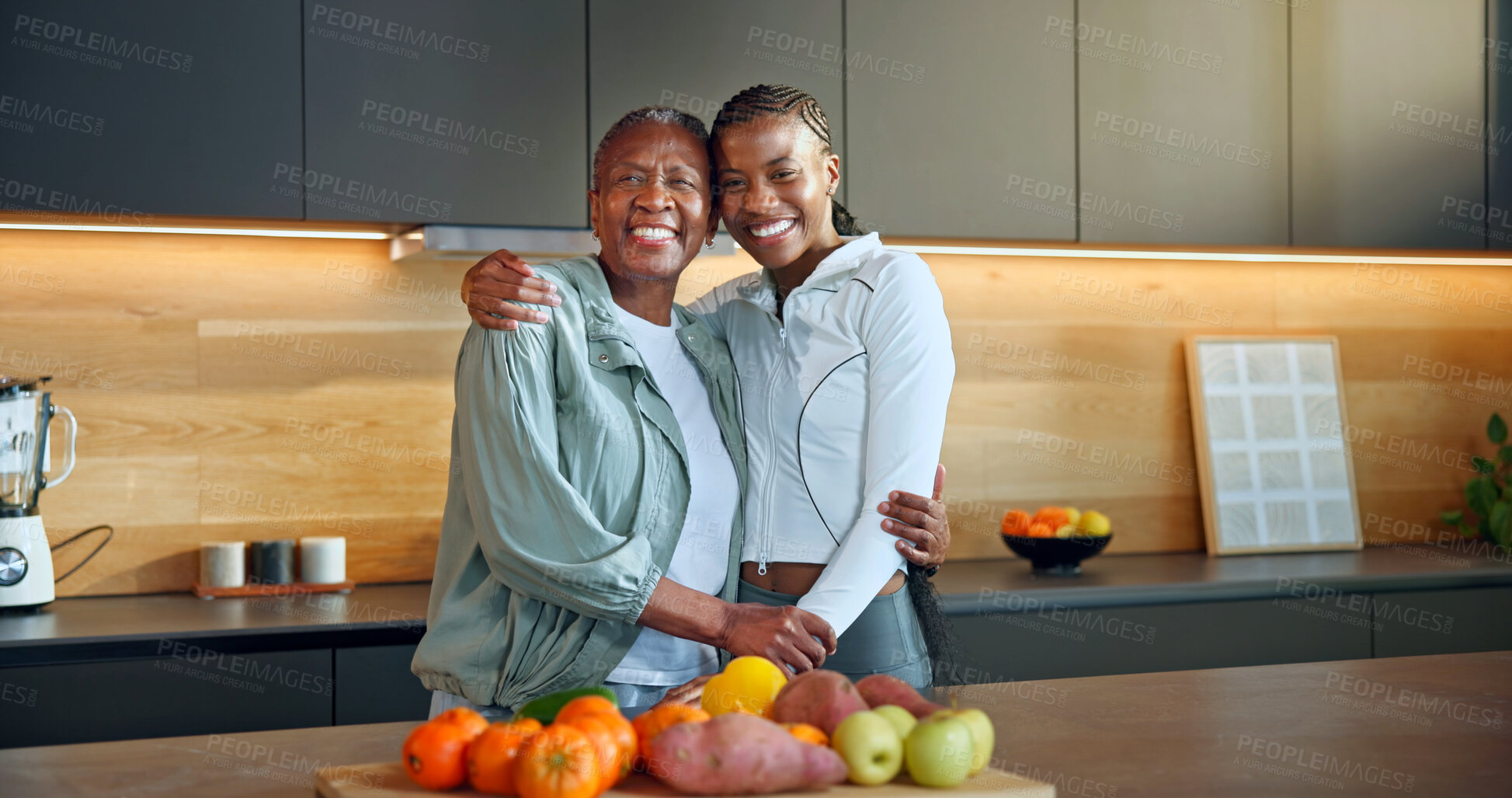 Buy stock photo Family, portrait and women with grocery in kitchen, laughing and embrace with senior mother in home. Black people, hug and elderly parent with fruit, happiness and bonding together in apartment