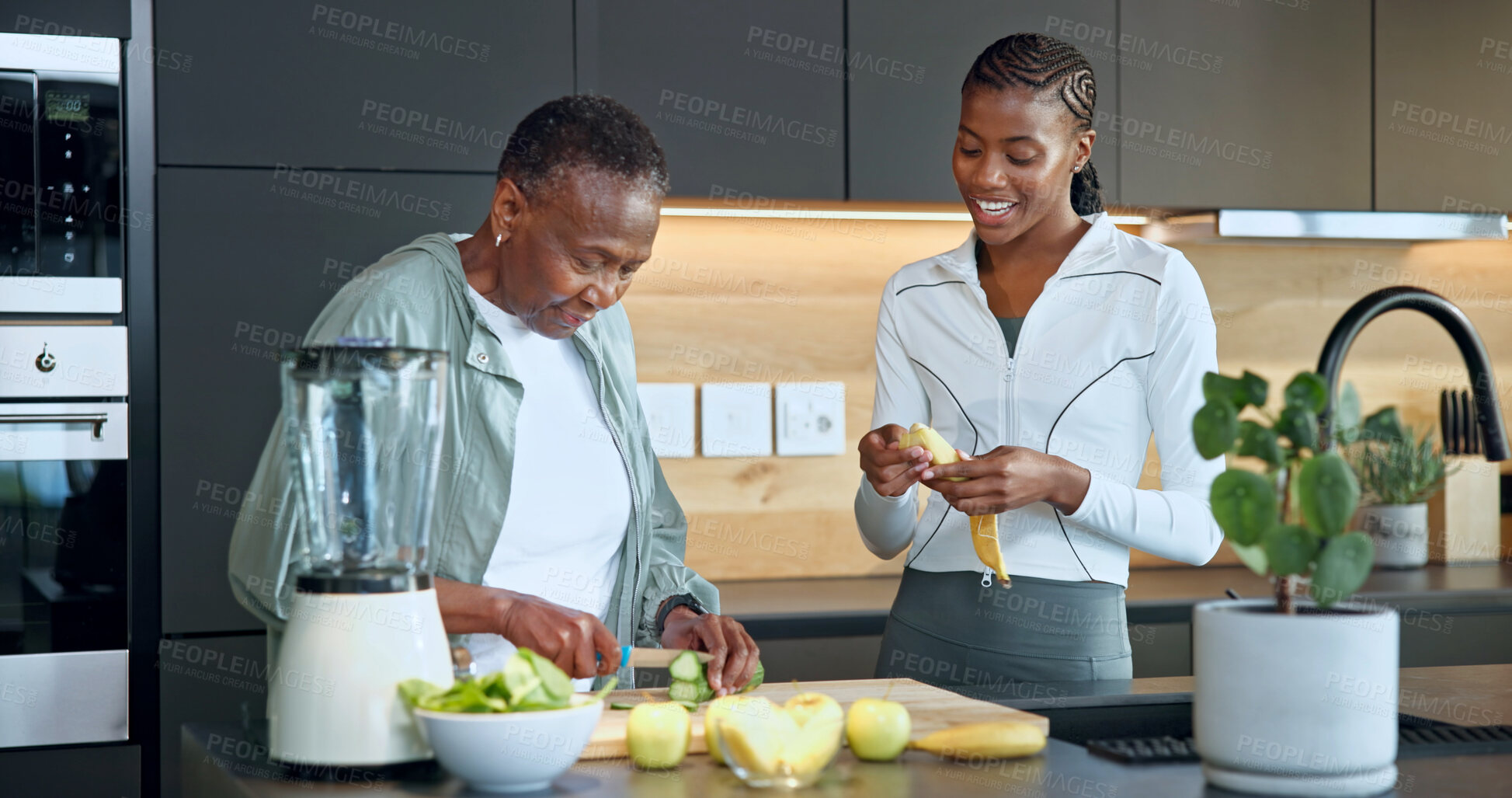 Buy stock photo Old woman, daughter and fruit at house with smile, healthy drink and fresh produce for nutrition. Happy, black family and senior person in kitchen with blender, organic ingredients and detox beverage