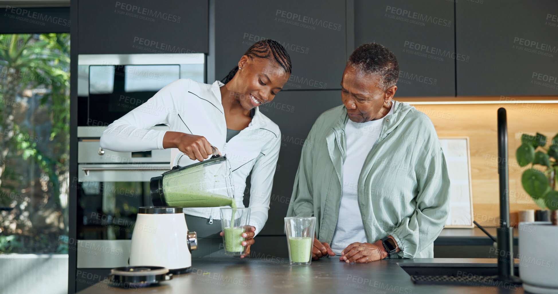 Buy stock photo Smile, black family and glass at house with smoothie, healthy drink and green juice for gut health. Happy, old woman and daughter in kitchen with blender, organic ingredients and beverage for detox