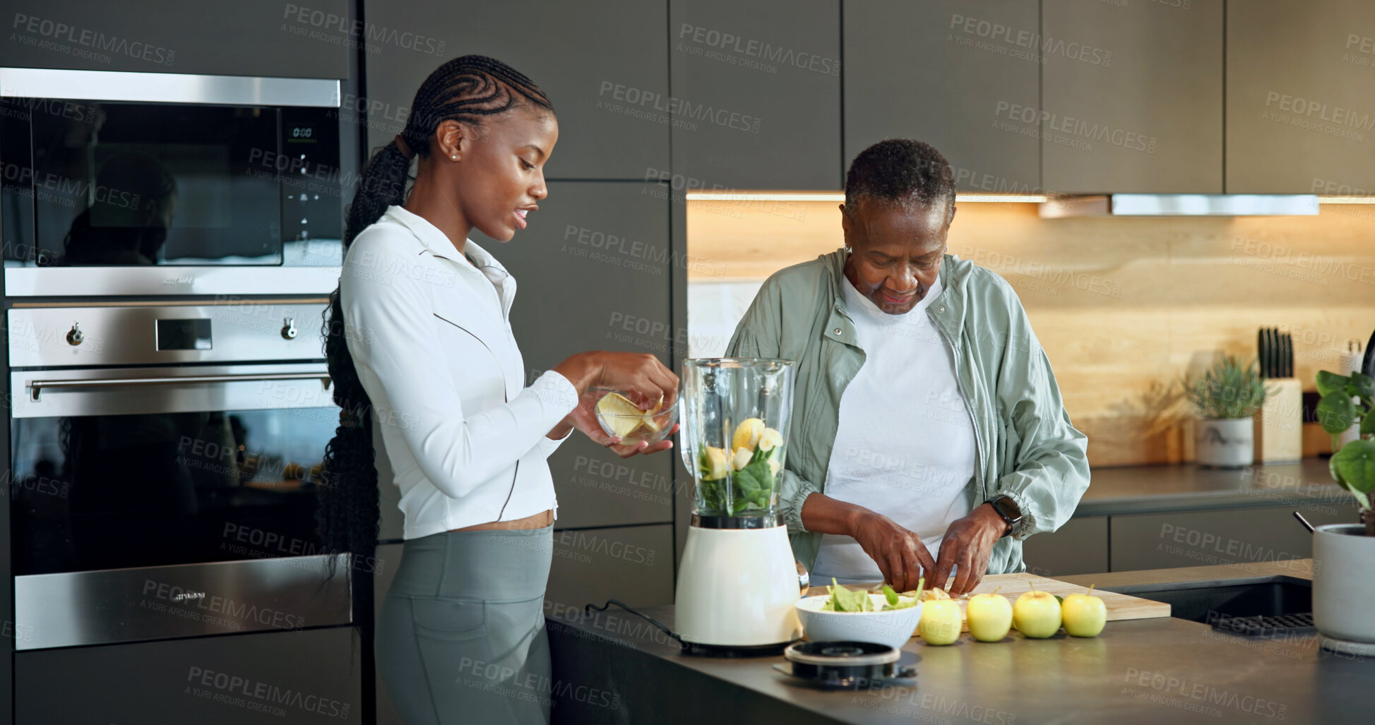 Buy stock photo Old woman, daughter and cutting at house with fruit , healthy drink and fresh produce for diet. Black family, helping or senior person in kitchen with blender, organic ingredients and detox beverage 