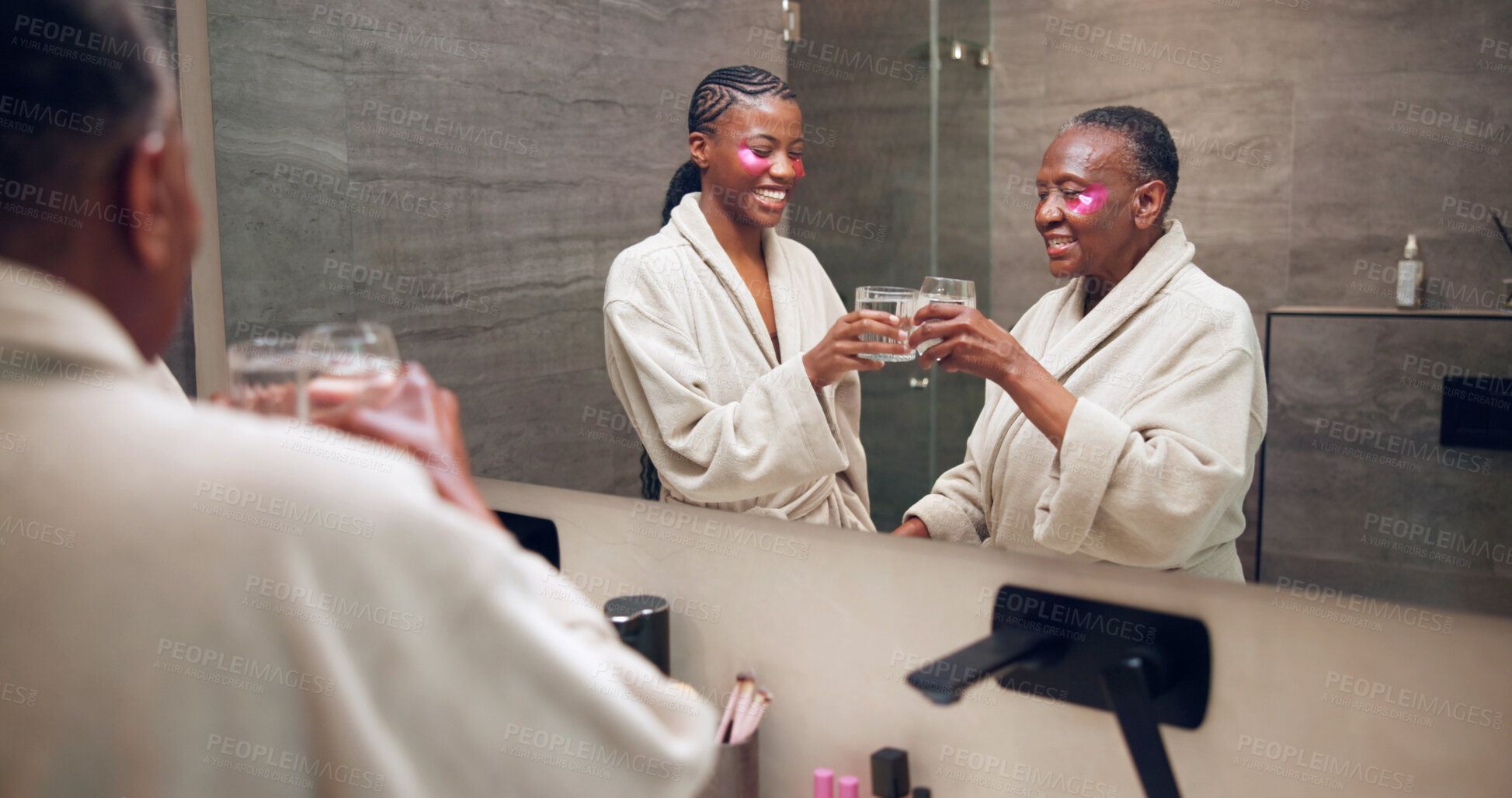 Buy stock photo Toast, skincare and woman with senior mom for wellness, eye mask and pamper for bonding and love. Family, drinks and African daughter, mother and mirror for hygiene, self care and beauty in home