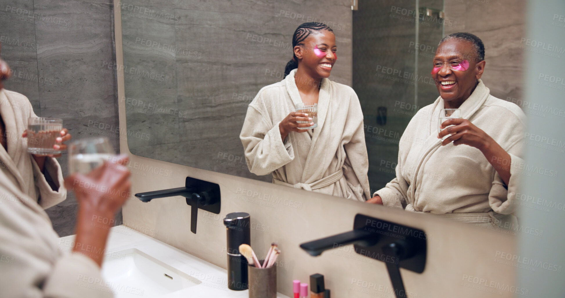 Buy stock photo Bathroom, drinks and woman with senior mom for wellness, skincare and grooming together for bonding. Family, happy and African daughter, mother and laugh for pamper, self care and beauty in home