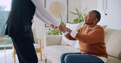 Buy stock photo Helping, old woman and holding hands with nurse in nursing home, connection or assistance in lounge. Healthcare, caregiver and senior black person in living room, homecare and support for patient