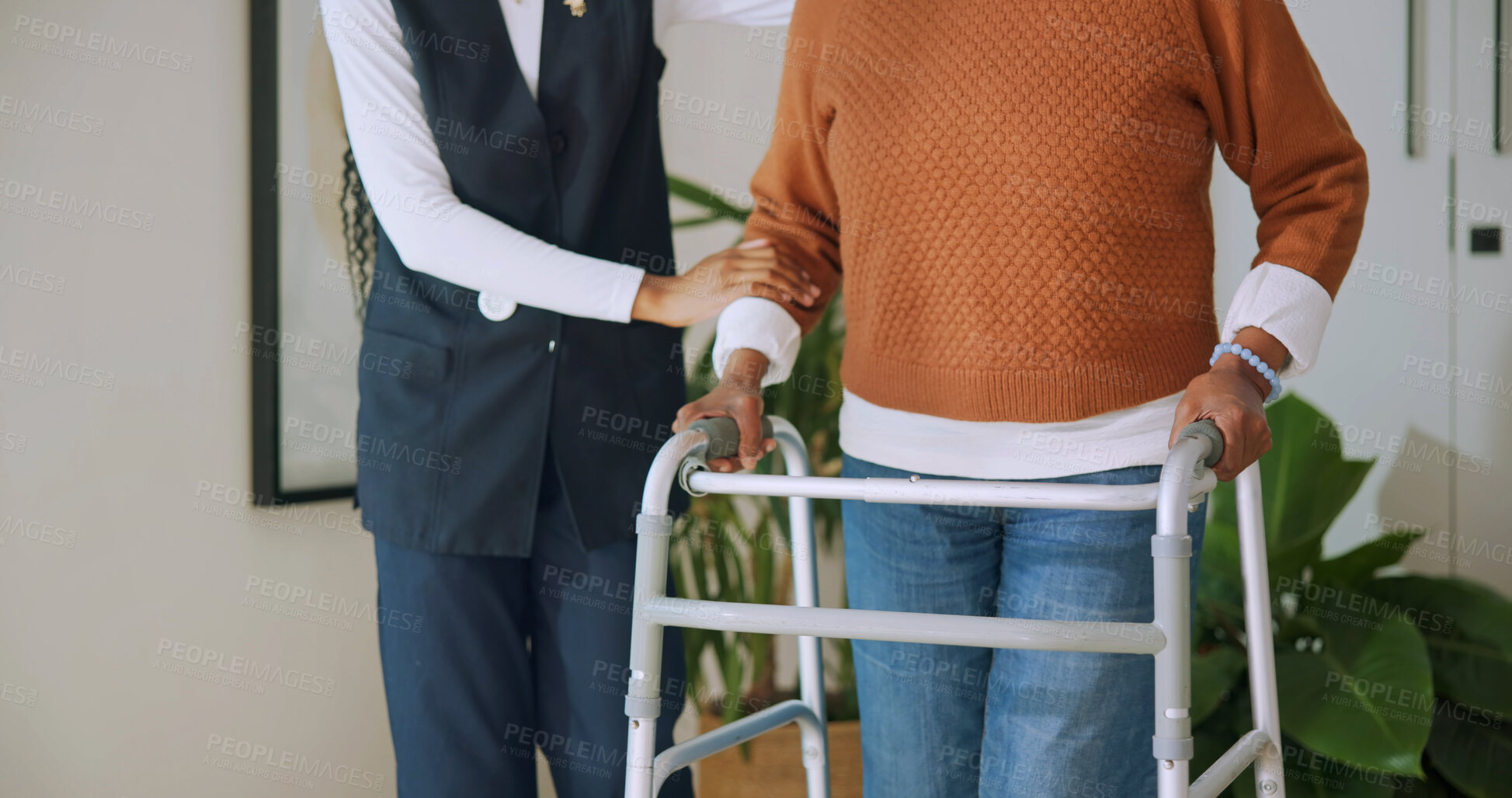 Buy stock photo Caregiver, support and hands with walker in nursing home, rehabilitation or help for senior patient. Homecare, nurse and walking with elderly person, healthcare and assisted mobility for recovery