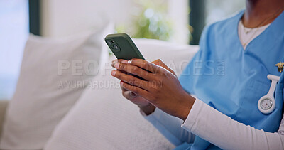 Buy stock photo Caregiver, hands and typing on couch with phone, healthcare or mobile app to clock in nursing home. Nurse, woman and online in workplace with tech, check schedule and website for medical research.