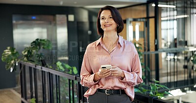 Buy stock photo Phone, smile and thinking with business woman in green office for connectivity or networking. App, mature employee and plants in eco friendly workplace for communication or sustianability project