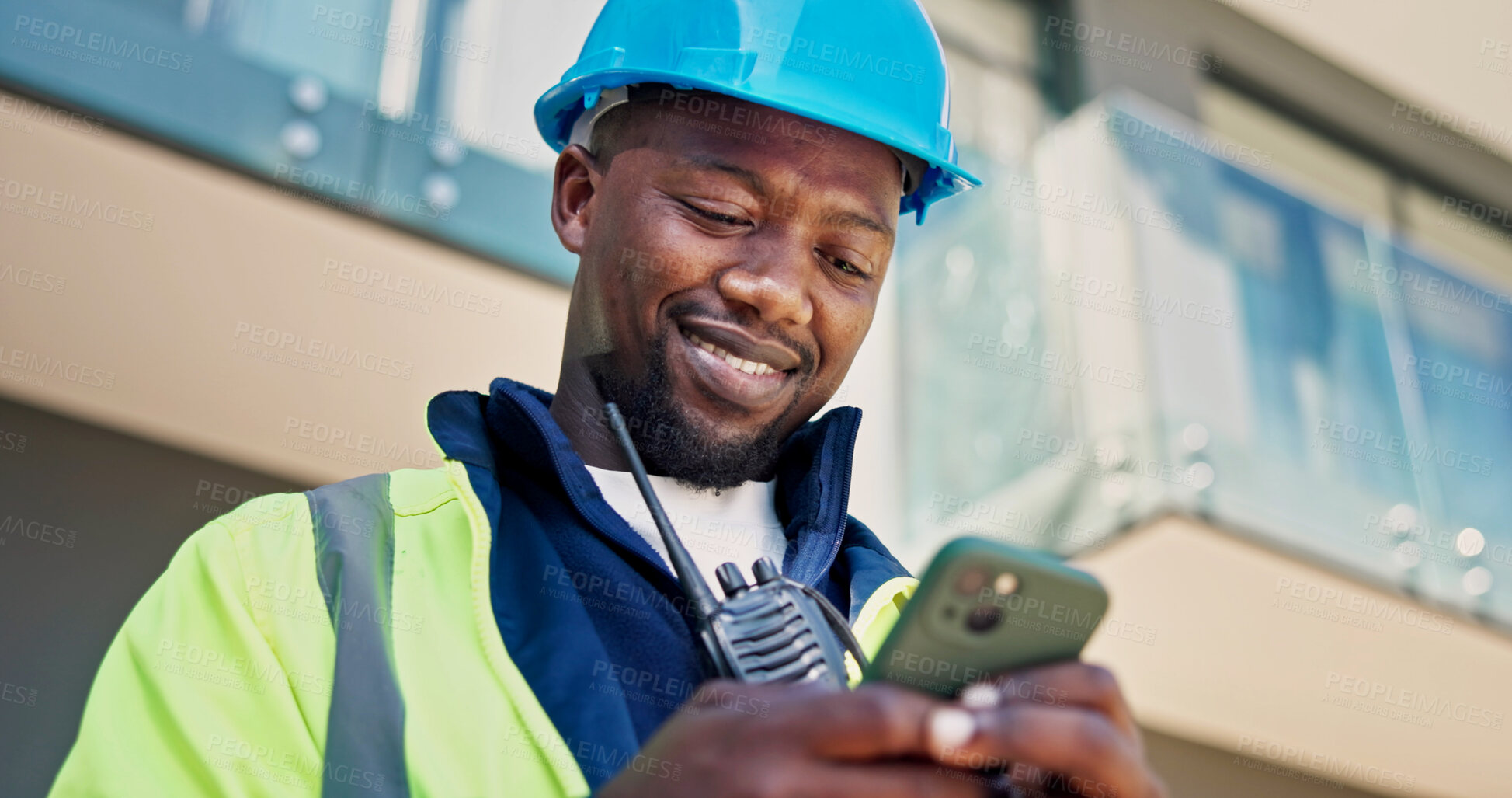 Buy stock photo Electrician, phone and black man with smile and inspection for building, planning or renovation. Engineer, person and message on tech for property development, construction site or remodeling project