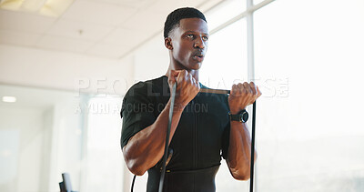 Buy stock photo Exercise, pull and man with rope in gym for strength training, fitness and bodybuilding workout. Sports, African person and ems equipment for muscle stimulation, intense activity and strong body