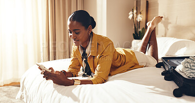 Buy stock photo Happy, woman and relax on hotel bed with phone, check itinerary and social media post for vacation. Person, travel plan and rest in accommodation with tech, mobile app or online research for holiday.