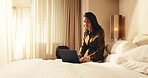 Woman, typing and laptop in hotel room for business trip, check schedule and planning for itinerary. Mature person, browsing and online in accommodation with computer, travel and calendar for work.
