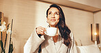 Happy, woman and thinking in hotel room with coffee, positive mindset and relax with calm vacation. Mature person, peaceful morning and smile in accommodation with tea, vision and holiday on weekend.