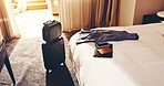 Luggage, tech and passport in empty hotel room for business trip, international event or conference. Suitcase, phone and ID documents in accommodation for overseas work, job convention and travel.