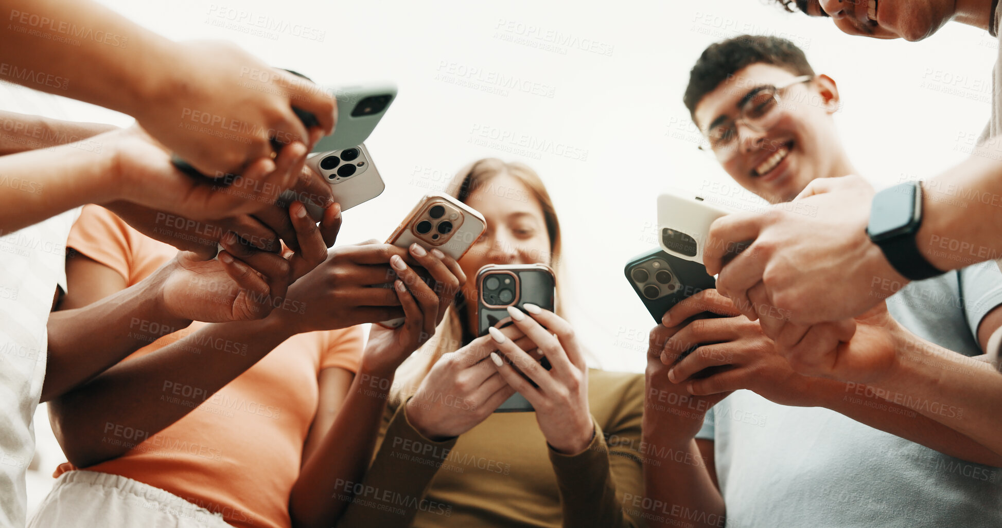 Buy stock photo Hands, happy friends and phone for connection outdoor, share contact or networking on social media. Group, people or low angle with mobile for communication together, download community app or text