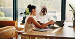Marriage, finance and mature couple on laptop for mortgage, online banking and bills in home. Talking, interracial relationship and man with woman with computer, financial report and budget payment