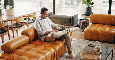 Buy stock photo Creative, remote work and happy man with laptop in lounge, writer and proofreading fiction in house. Freelancer, online and mature person with tech, typing and research for ebook on website in home