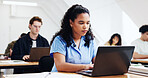 Typing, laptop and woman in class for learning, thesis review or student with college knowledge. Tech, reading and person study with university portal for academic task, course research or education